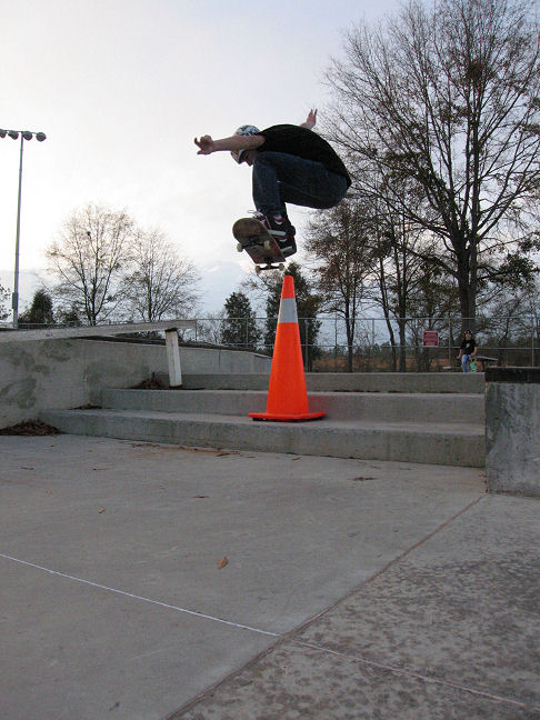 Steven pops a big ollie over the cone and stairs